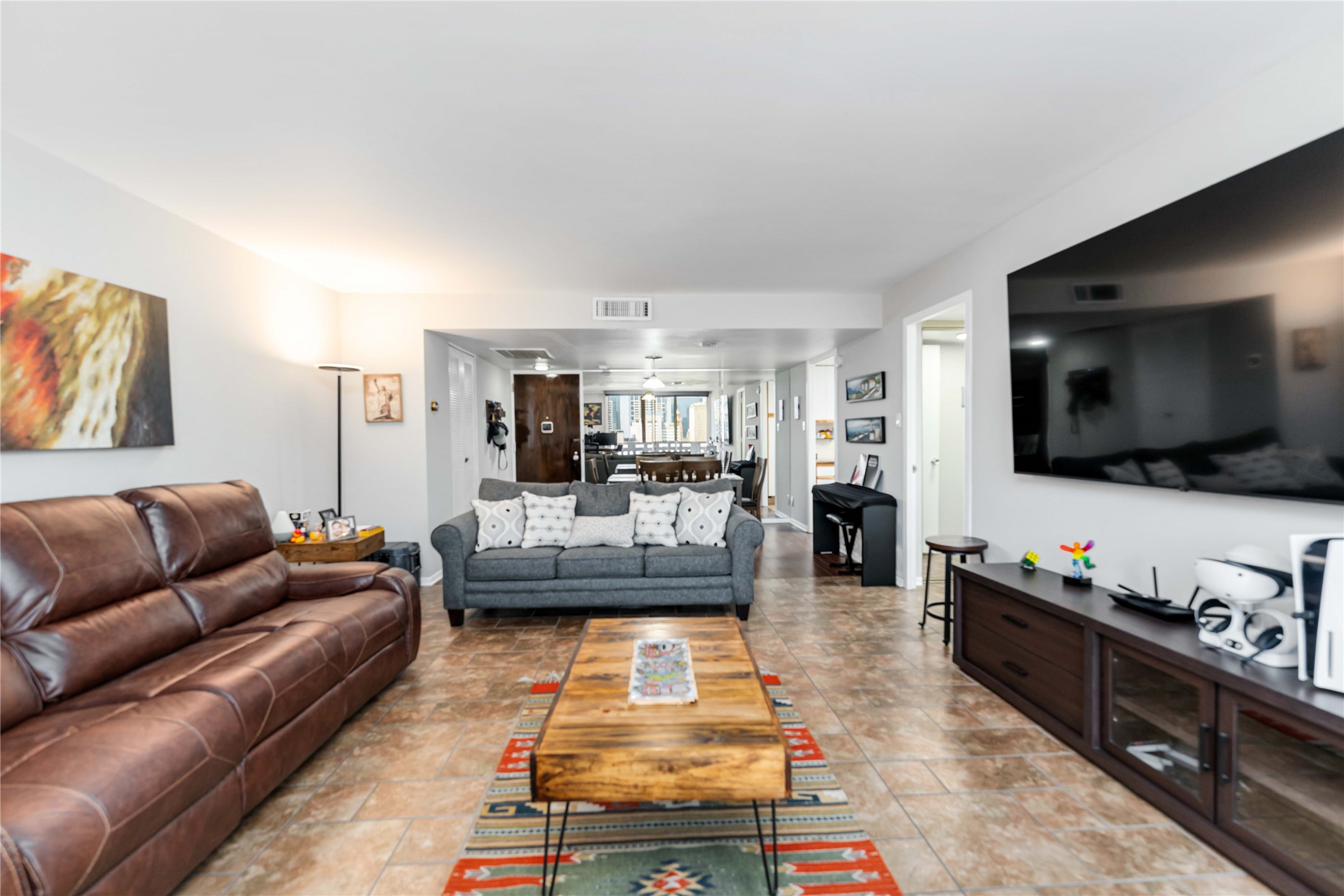 2016 Main Street, Unit 2305 Houston, TX 77002 - Photo 11 of 26 a living room with furniture and a flat screen tv