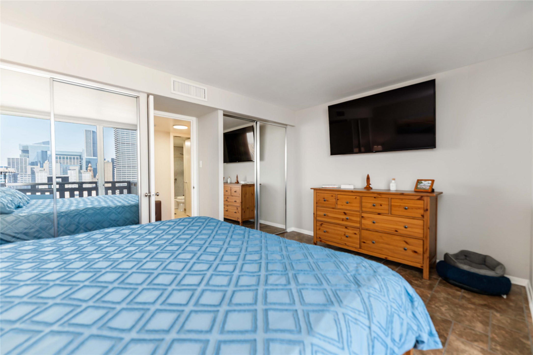 2016 Main Street, Unit 2305 Houston, TX 77002 - Photo 13 of 26 a bedroom with a bed and flat screen tv