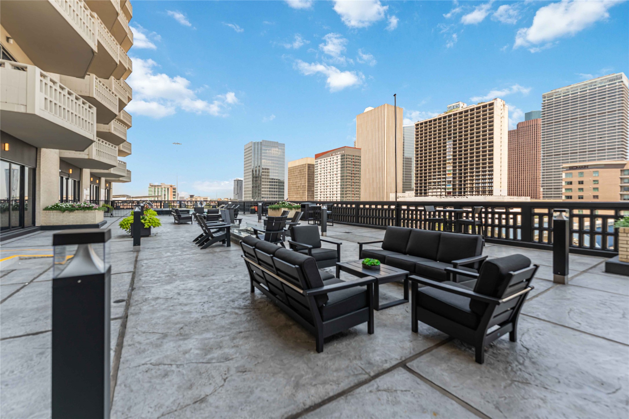 2016 Main Street, Unit 2305 Houston, TX 77002 - Photo 20 of 26 a living room with furniture and a fireplace