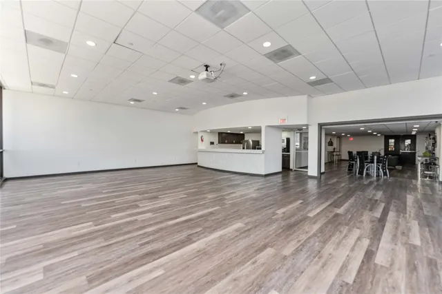a view of a room with stainless steel appliances wooden floors