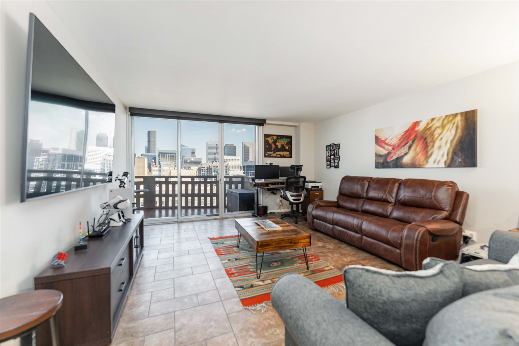 2016 Main Street, Unit 2305 Houston, TX 77002 - Photo 9 of 26 a living room with furniture and a floor to ceiling window