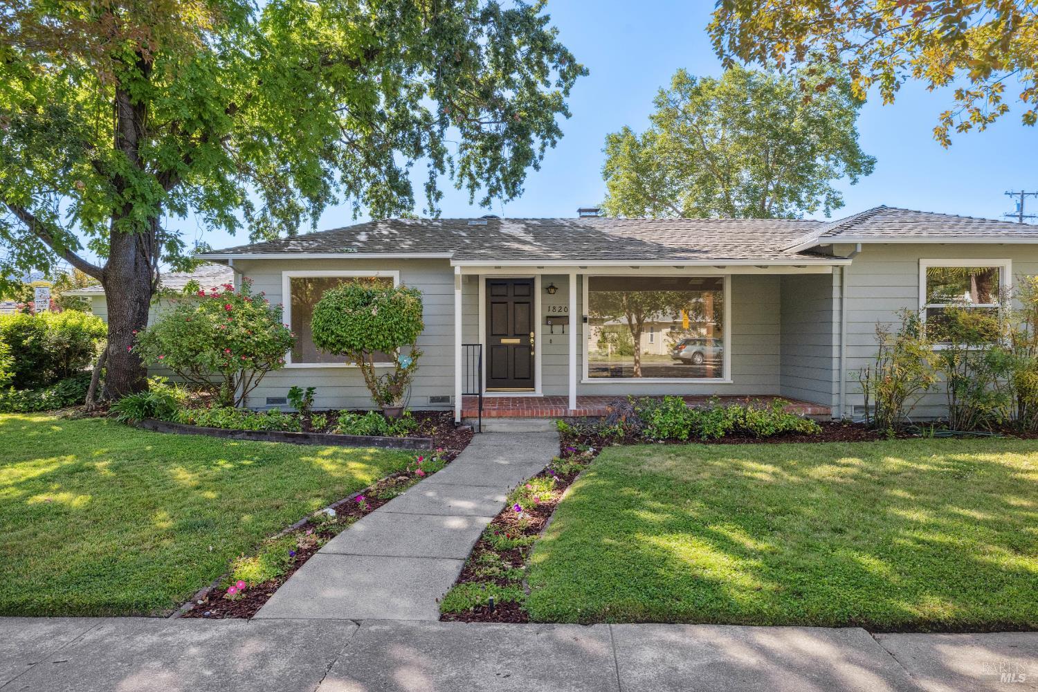 a view of a house with a yard and plants