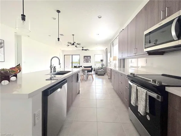 a kitchen with stainless steel appliances a sink stove and cabinets