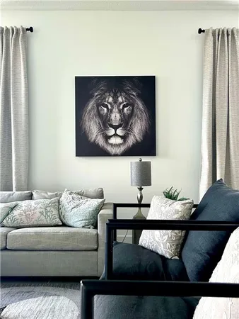 a living room with furniture and wall paintings