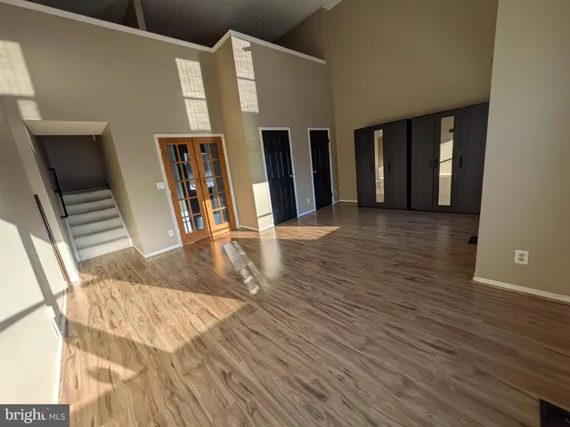 a view of a living room with furniture and wooden floor