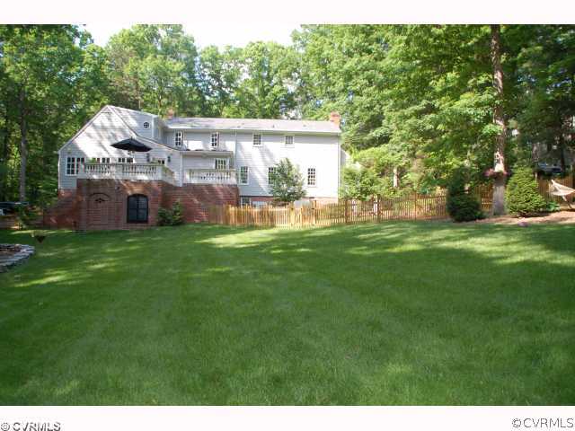 13421 Kingsmill Road Midlothian, VA 23113 - Photo 2 of 12 a view of a big house with a big yard and large tree