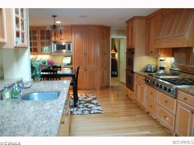 13421 Kingsmill Road Midlothian, VA 23113 - Photo 6 of 12 a kitchen with stainless steel appliances granite countertop a stove refrigerator and cabinets