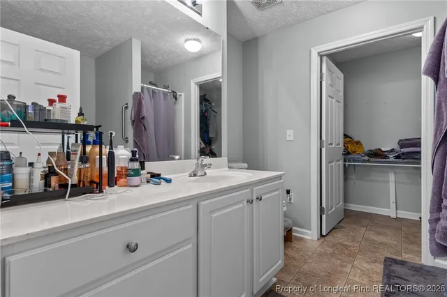 a room with a sink vanity and a mirror