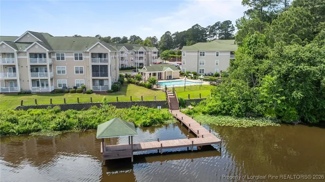 a view of a house with a yard and a large pool