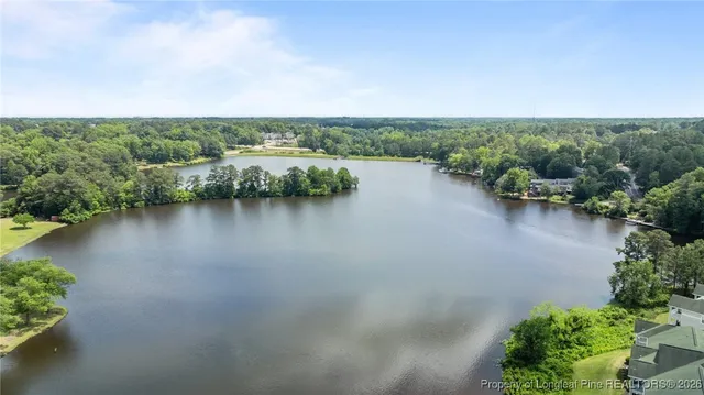 an aerial view of lake and residential houses with outdoor space