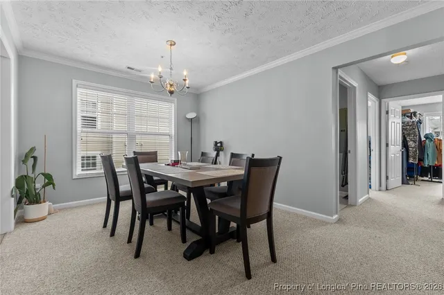 a view of a dining room with furniture and window