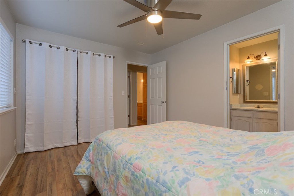 2732 Lowell Drive Chico, CA 95973 - Photo 19 of 40 a bedroom with a large bed and a chandelier