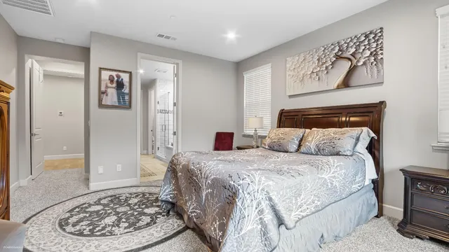 a bedroom with a bed and a painting on the wall