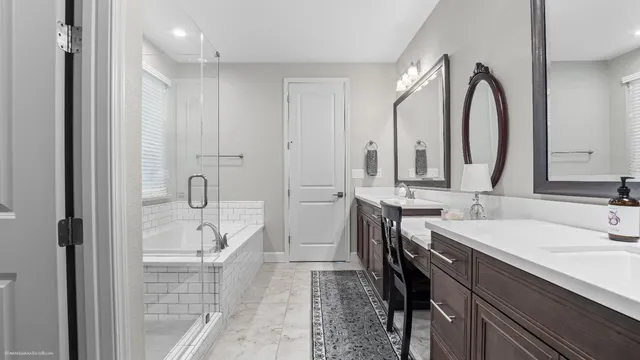 a bathroom with a double vanity sink mirror and shower