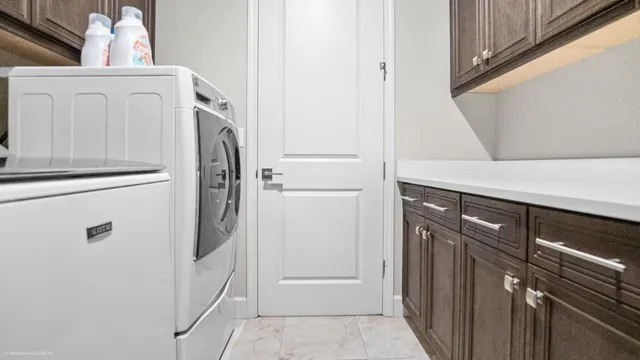 a metallic refrigerator freezer sitting in a kitchen