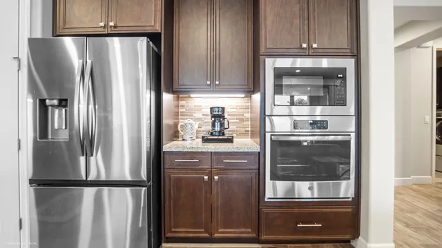 a front view of house with outdoor seating and water view