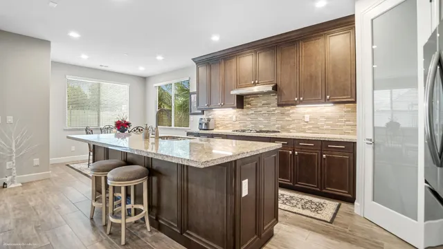 a kitchen with stainless steel appliances granite countertop wooden cabinets and a granite counter tops