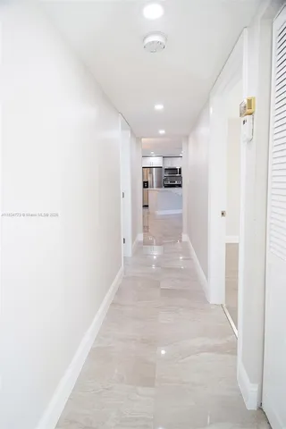 a view of a hallway with a kitchen