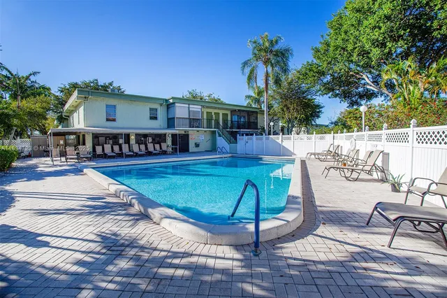 a swimming pool with outdoor seating and yard