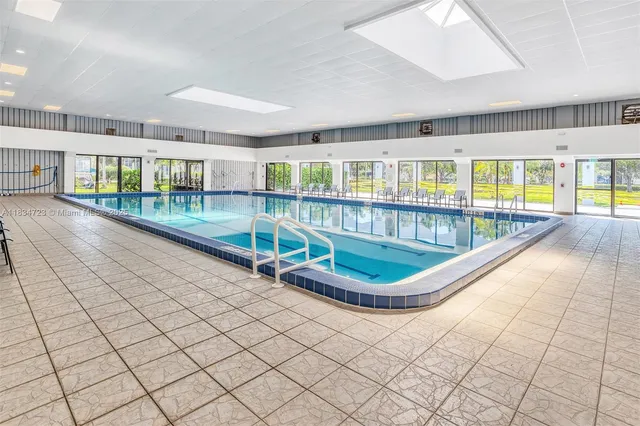 an outdoor view of a house with a large window