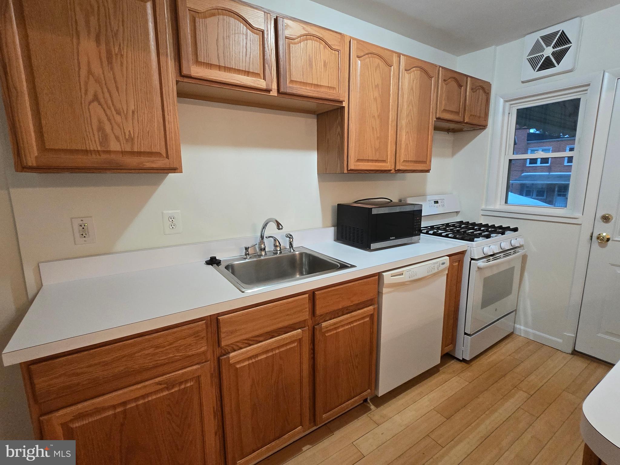 8625 Black Oak Road Baltimore, MD 21234 - Photo 24 of 36 a kitchen with sink cabinets and stainless steel appliances