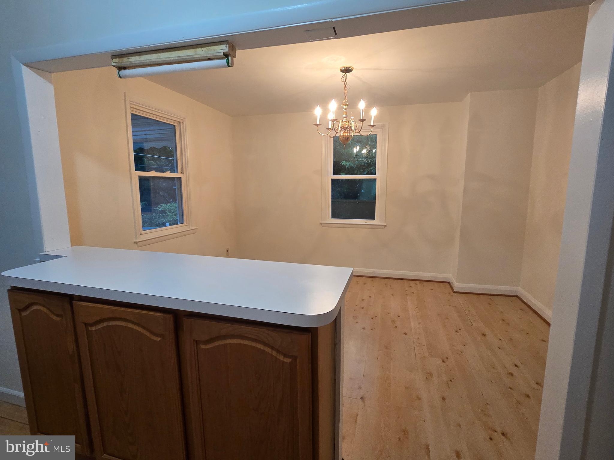 8625 Black Oak Road Baltimore, MD 21234 - Photo 25 of 36 a room that has a lot of cabinets and wooden floor