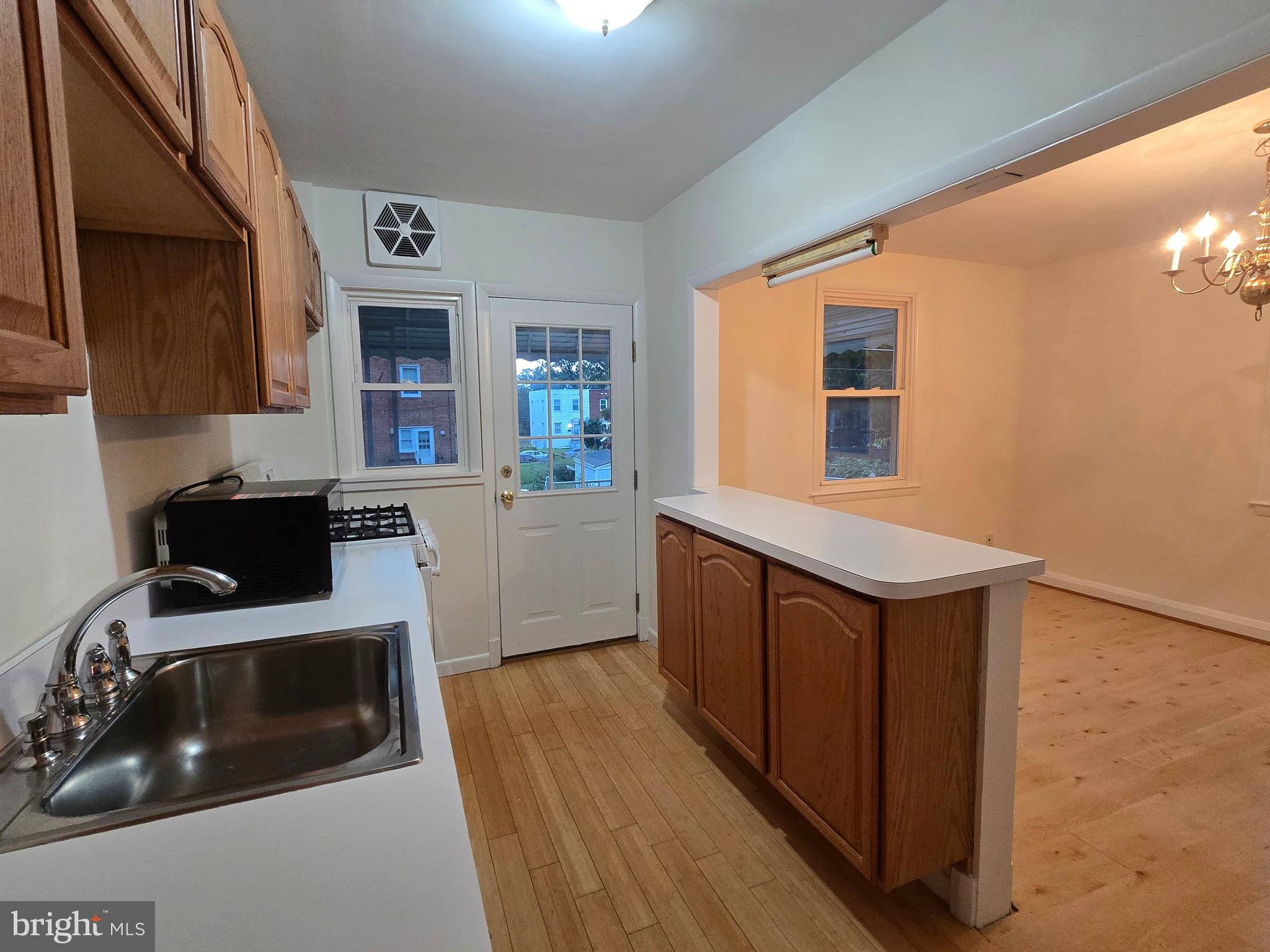 8625 Black Oak Road Baltimore, MD 21234 - Photo 26 of 36 a kitchen with wooden cabinets and a sink