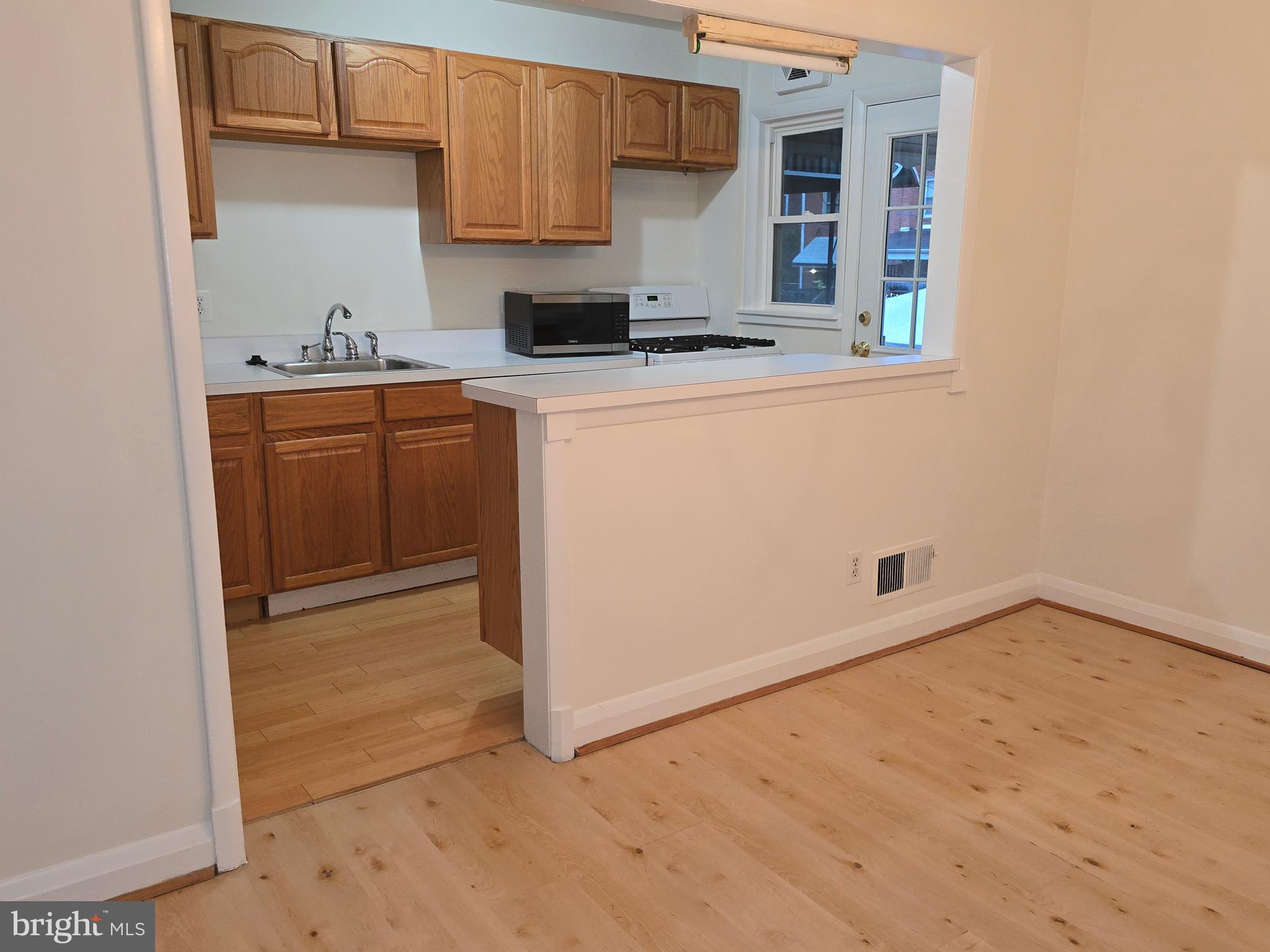 8625 Black Oak Road Baltimore, MD 21234 - Photo 27 of 36 a kitchen with a sink a stove and cabinets