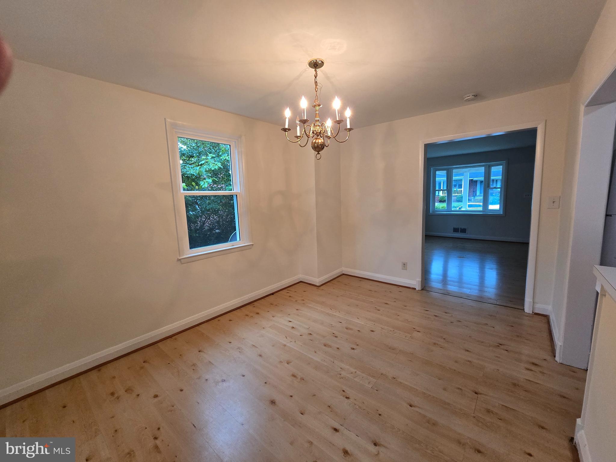 8625 Black Oak Road Baltimore, MD 21234 - Photo 29 of 36 a view of an empty room with window and wooden floor