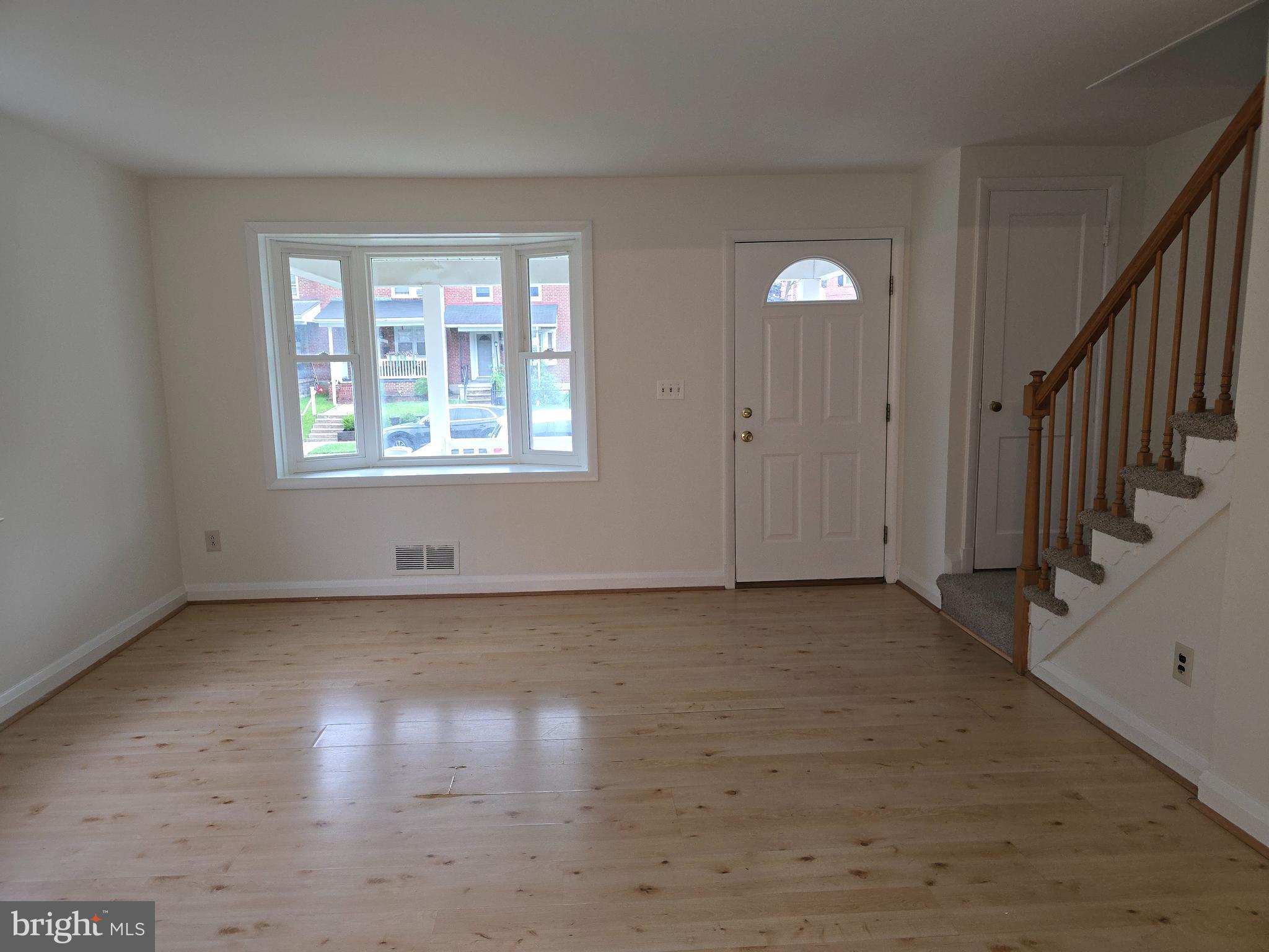 8625 Black Oak Road Baltimore, MD 21234 - Photo 3 of 36 a view of an empty room with wooden floor and a window