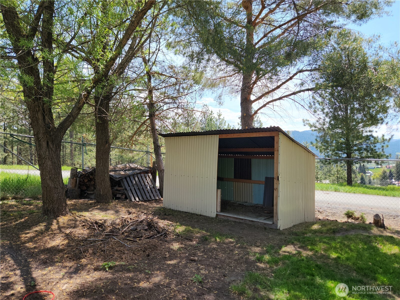 1023 North Adams Street Republic, WA 99166 - Photo 27 of 33 a view of a house with a yard and garage