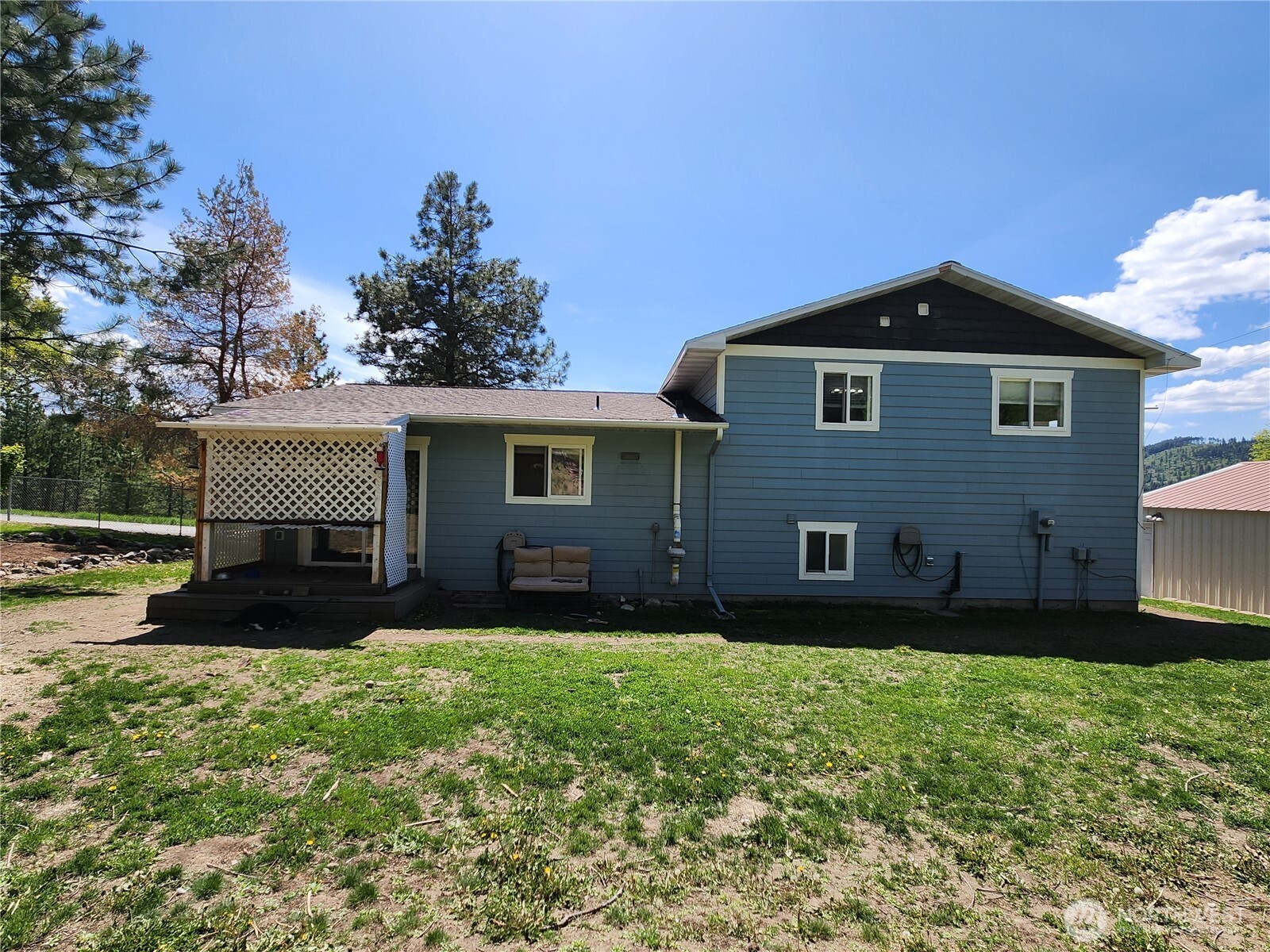 1023 North Adams Street Republic, WA 99166 - Photo 29 of 33 a front view of a house with a yard and trees