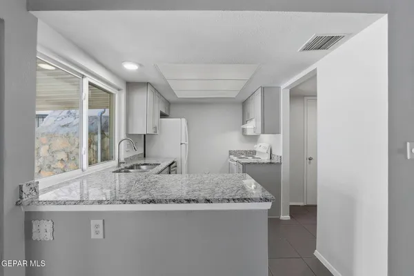 a bathroom with granite countertop sink and a mirror