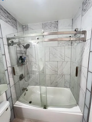 a white bath tub sitting next to a white sink and vanity