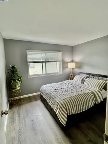 a bedroom with a bed and windows