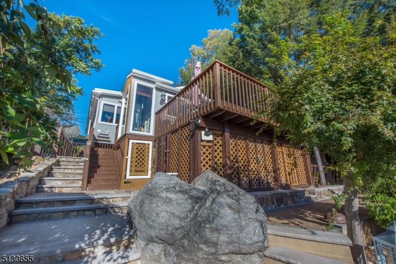 25 Lake Road Denville, NJ 07834 - Photo 12 of 45 a front view of a house with a garden