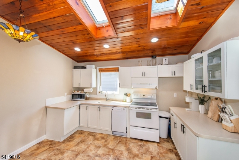 25 Lake Road Denville, NJ 07834 - Photo 15 of 45 a kitchen that has a sink a stove and a refrigerator