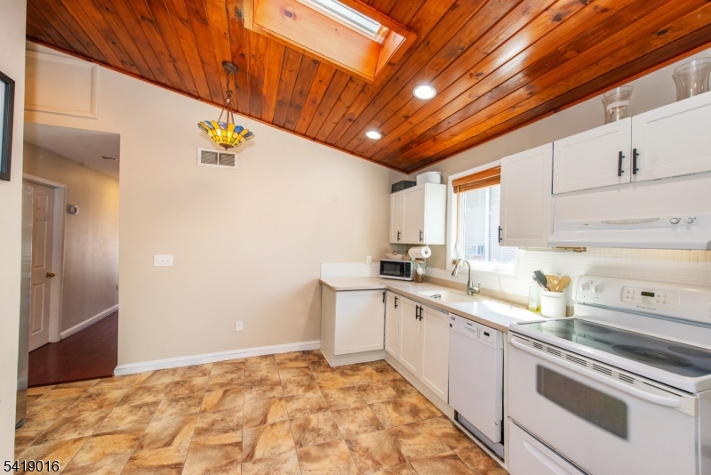 25 Lake Road Denville, NJ 07834 - Photo 17 of 45 a kitchen with a sink stove and cabinets