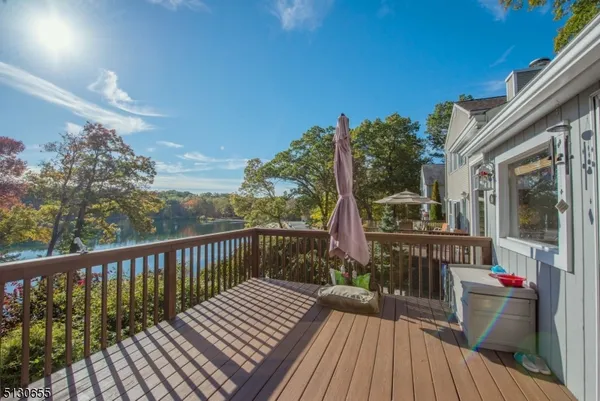 a view of a balcony with dining table and chairs