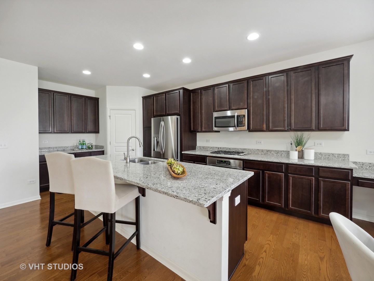 2940 Chevy Chase Lane Naperville, IL 60564 - Photo 7 of 38 a kitchen with stainless steel appliances granite countertop a kitchen island hardwood floor sink and stove