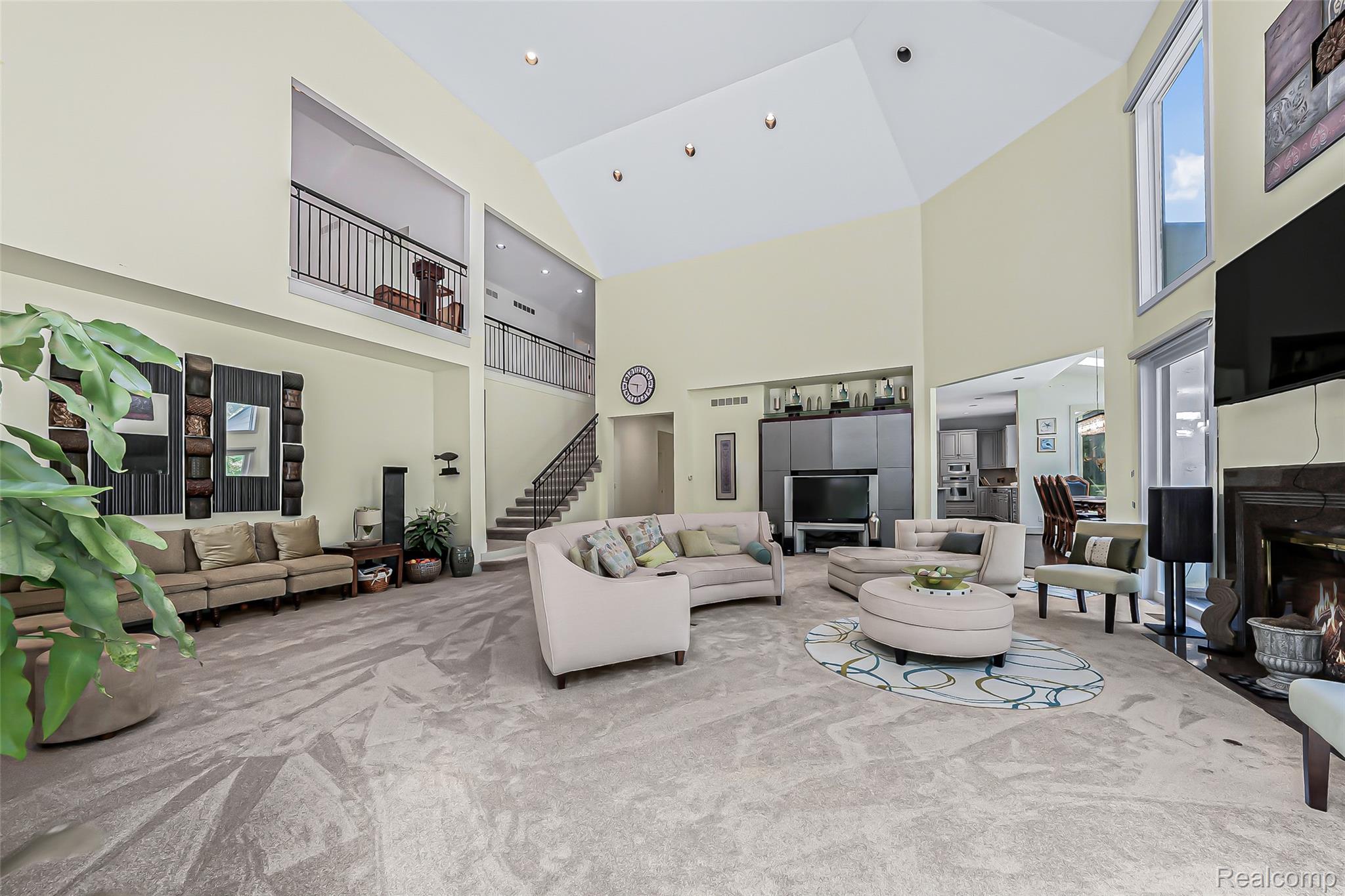 2785 Cranbrook Ridge Court Rochester, MI 48306 - Photo 51 of 99 Vaulted ceiling, recessed lighting, stone fireplace, upper-level balcony, and a built-in media console