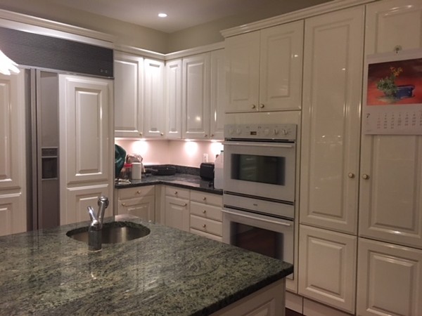 45 Arnold Road Wellesley, MA 02481 - Photo 13 of 15 a kitchen with kitchen island granite countertop a stove a sink and a refrigerator