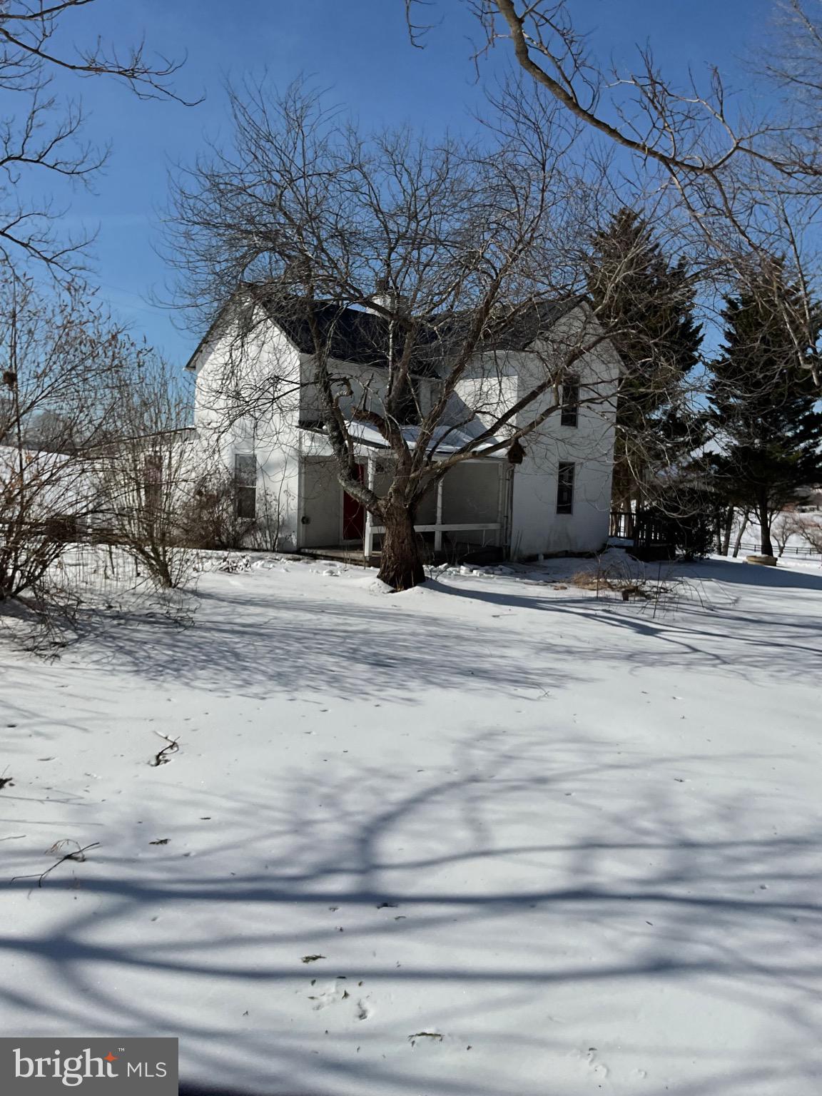 Charming white house in a snowy landscape.