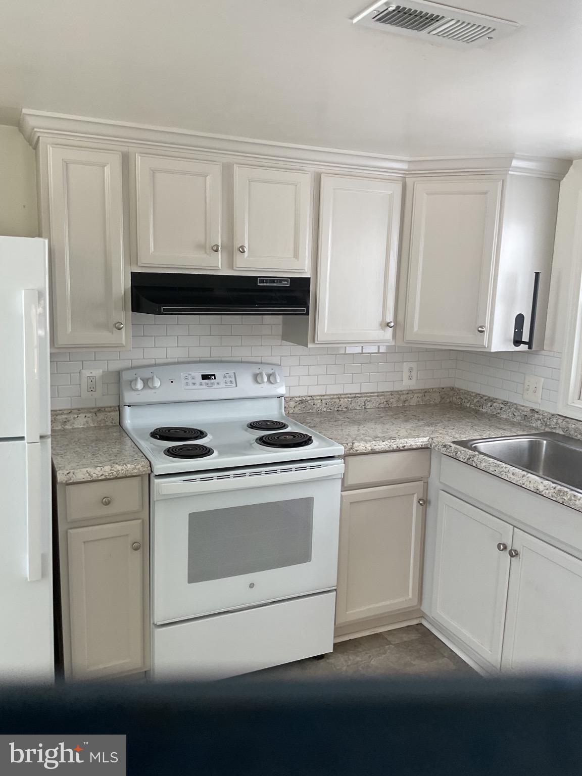 6774 Leeds Manor Road Marshall, VA 20115 - Photo 10 of 17 Modern kitchen with sleek white cabinetry.