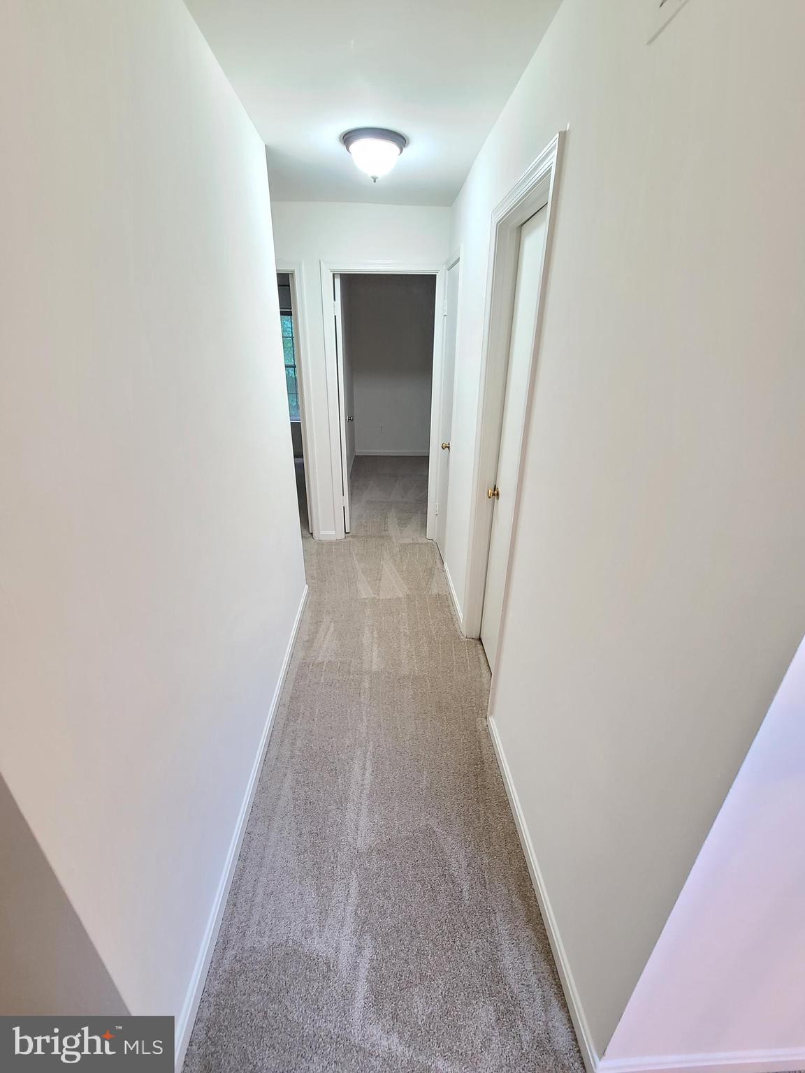 1427 Casino Circle Silver Spring, MD 20906 - Photo 13 of 34 a view of a hallway with wooden floor and a ceiling fan