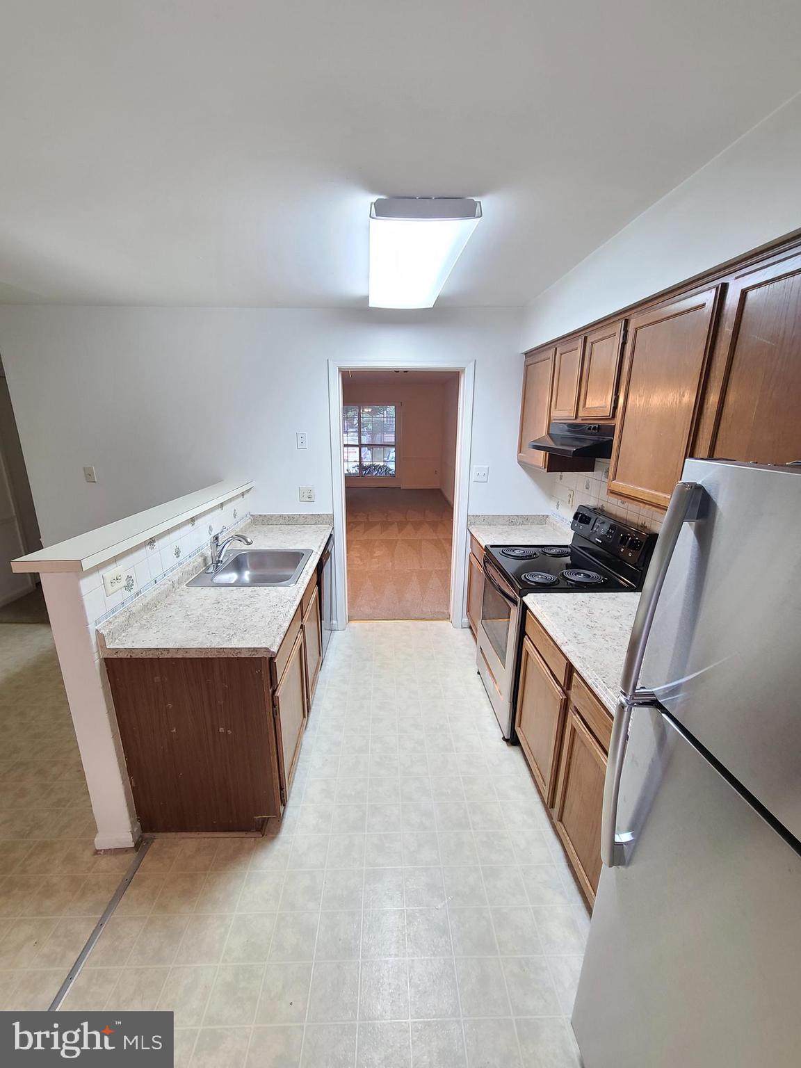 1427 Casino Circle Silver Spring, MD 20906 - Photo 7 of 34 a kitchen with stainless steel appliances granite countertop a sink stove and refrigerator