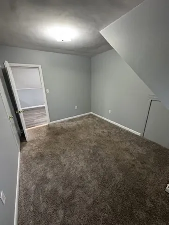 an empty room with a empty space and a window