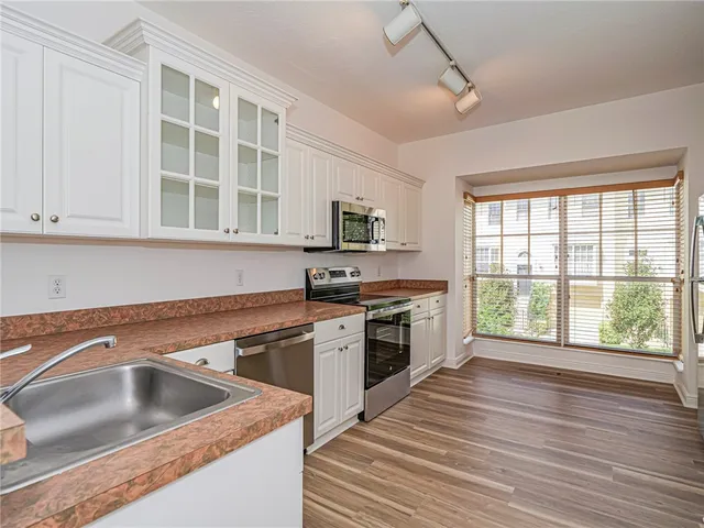 a kitchen with a stove a sink and a microwave
