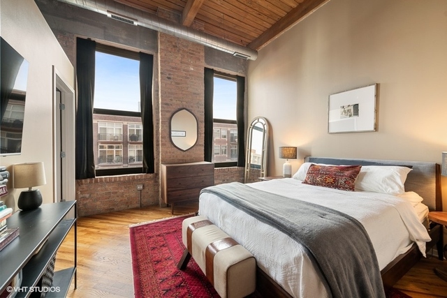 1040 West Adams Street, Unit 610 Chicago, IL 60607 - Photo 11 of 24 a bedroom with a large bed and a large window
