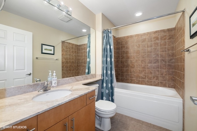 1040 West Adams Street, Unit 610 Chicago, IL 60607 - Photo 16 of 24 a bathroom with a sink a toilet and shower